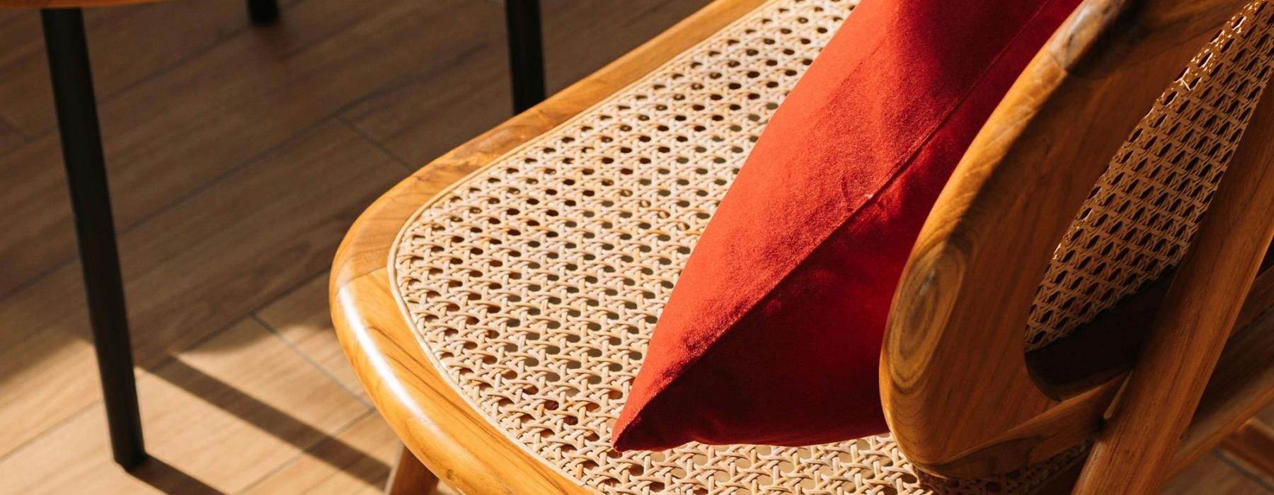 A chair with a cushion in the sunlight