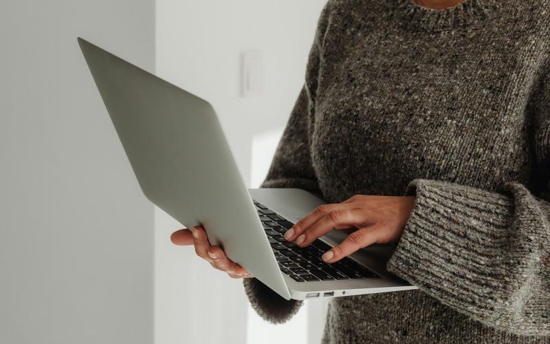 A person holding a laptop.